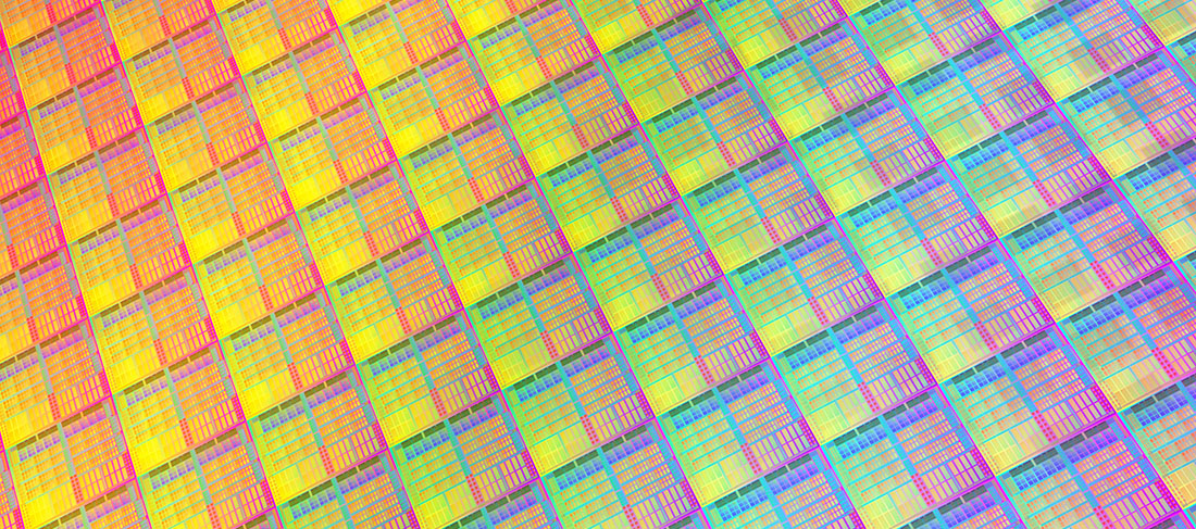 A silicon-carbide wafer reflects light in a rainbow of colors.